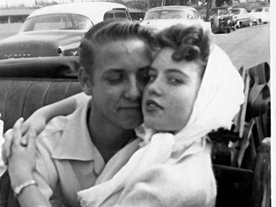 a group of people sitting around a car