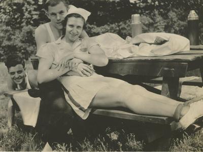 a vintage photo of a group of people sitting posing for the camera