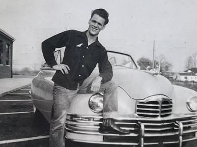 a vintage photo of a man in a car