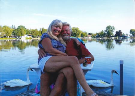 Mommy and Daddy on the dock with swans