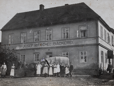 old bakery with people and carriage in the front