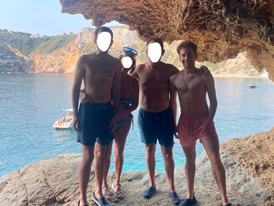 a group of people standing on a rocky beach